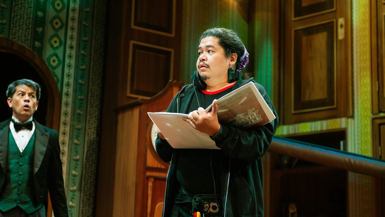 Dennis (Greg Ayers) watches as lighting and sound operator Trevor (Tasi Alabastro) finds himself onstage in "The Play That Goes Wrong," presented by San Francisco Playhouse September 21 - November 9. "The Play That Goes Wrong" production photo.