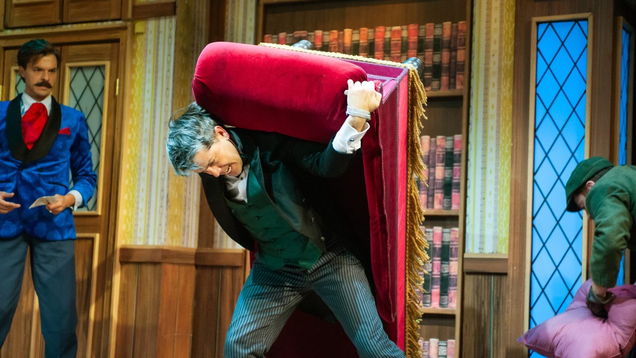 Jonathan (Adam Griffith) watches as Dennis (Greg Ayers) moves scenery in "The Play That Goes Wrong," presented by San Francisco Playhouse September 21 - November 9. "The Play That Goes Wrong" production photo.
