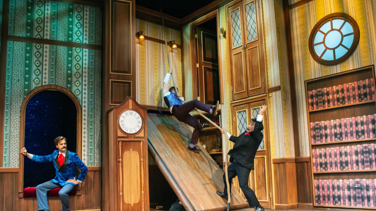 Jonathan (Adam Griffith) watches as Robert (Patrick Russell) and Chris (Phil Wong) lose footing in "The Play That Goes Wrong," presented by San Francisco Playhouse September 21 - November 9. "The Play That Goes Wrong" production photo.