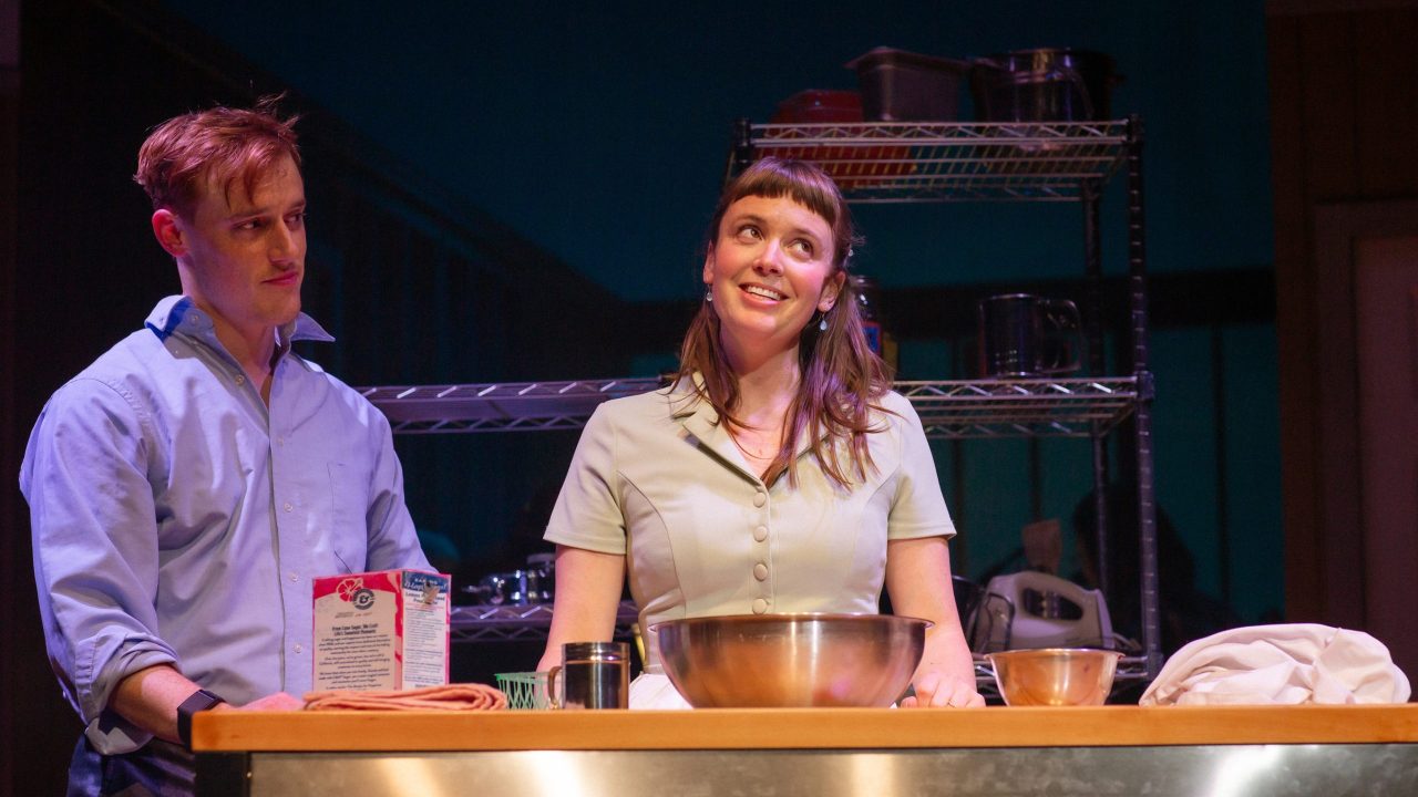 Dr. Pomatter (Zeke Edmonds) learns from Jenna (Ruby Day) how to bake a pie in "Waitress," presented by San Francisco Playhouse November 21 – January 18. "Waitress" production photo.
