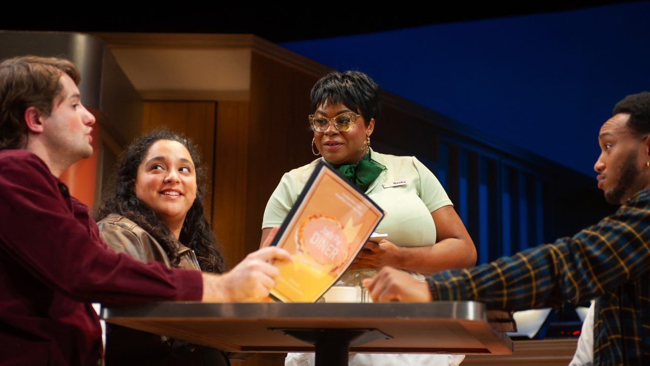 Becky (center - Tanika Baptiste) serves diner patrons (Milo Boland, Alexandra Rivers, and Jordan Covington) in "Waitress," presented by San Francisco Playhouse November 21 – January 18. "Waitress" production photo.