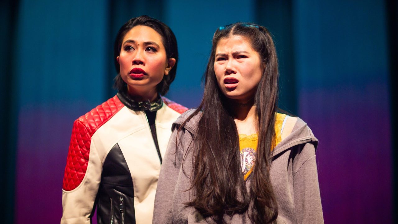 Exotic Deadly (Francesca Fernandez) influences Ami (Ana Ming Bostwick-Singer) to rebel in San Francisco Playhouse's "Exotic Deadly: Or the MSG Play," performing January 30 - March 8. Exotic Deadly (Francesca Fernandez) influences Ami (Ana Ming Bostwick-Singer) to rebel in San Francisco Playhouse's "Exotic Deadly: Or the MSG Play," performing January 30 - March 8.