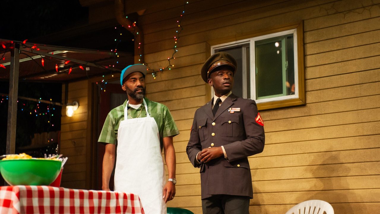 Rev (Ron Chapman) prepares the meats as Larry (Samuel Ademola) arrives to the barbecue in "Fat Ham," presented by San Francisco Playhouse March 20 - April 19. Rev (Ron Chapman) prepares the meats as Larry (Samuel Ademola) arrives to the barbecue in "Fat Ham," presented by San Francisco Playhouse March 20 - April 19.
