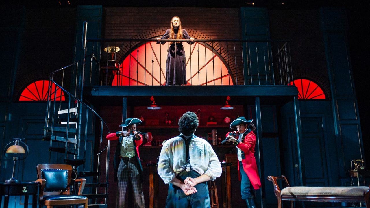 Eliza (upper center- Jillian A. Smith) fantasizes punishment for Professor Higgins (lower center- Adam Magill) at the hands of a firing squad (left- Kareem Jenkins, right- Chachi Delgado) in San Francisco Playhouse's "My Fair Lady," performing July 3 - September 13, 2025. Eliza (upper center- Jillian A. Smith) fantasizes punishment for Professor Higgins (lower center- Adam Magill) at the hands of a firing squad (left- Kareem Jenkins, right- Chachi Delgado) in San Francisco Playhouse's "My Fair Lady," performing July 3 - September 13, 2025.