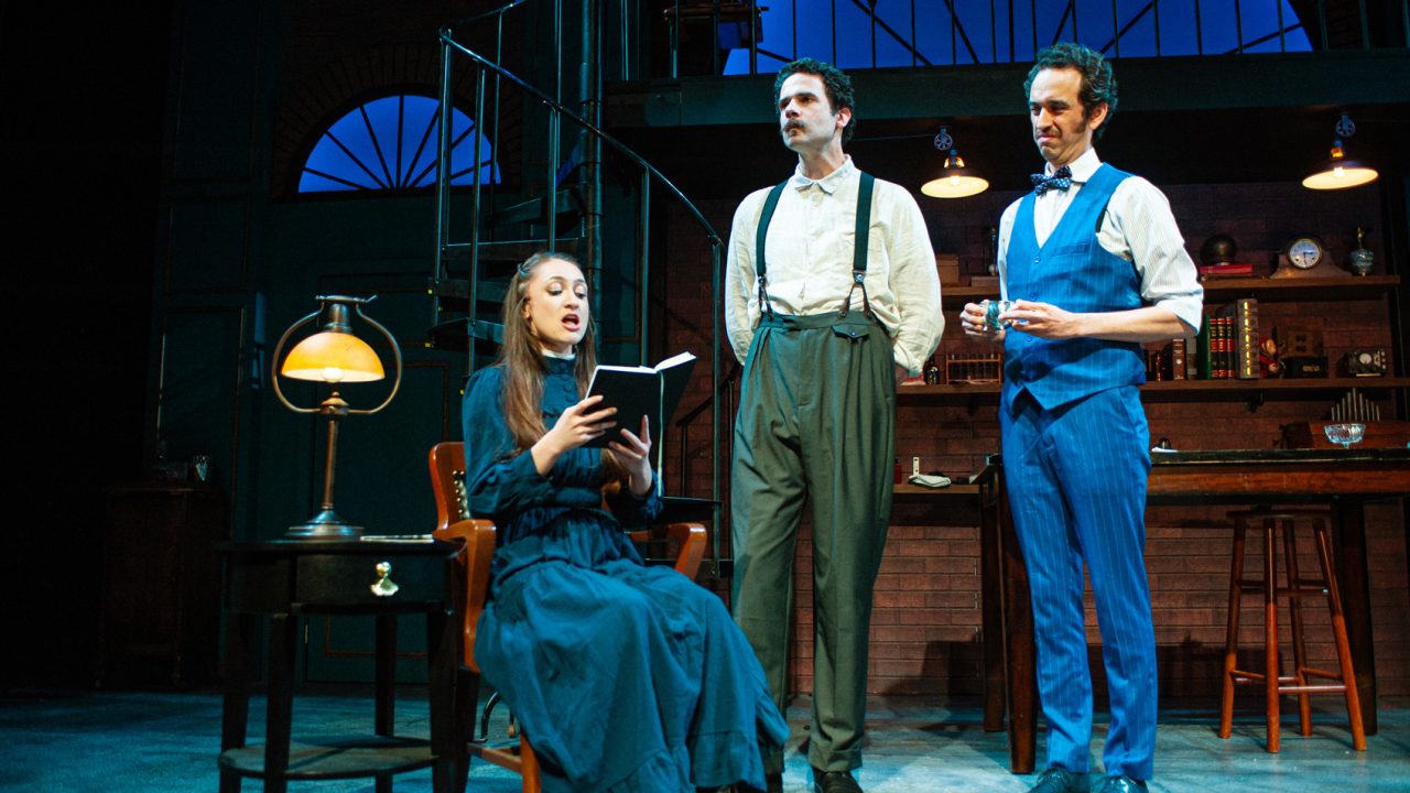 Eliza (Jillian A. Smith) struggles with pronunciation much to the chagrin of Professor Higgins (Adam Magill) and Colonel Pickering (Brady Morales-Woolery) in San Francisco Playhouse's "My Fair Lady," performing July 3 - September 13, 2025. Eliza (Jillian A. Smith) struggles with pronunciation much to the chagrin of Professor Higgins (Adam Magill) and Colonel Pickering (Brady Morales-Woolery) in San Francisco Playhouse's "My Fair Lady," performing July 3 - September 13, 2025.