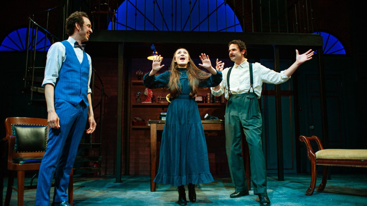 Colonel Pickering (Brady Morales-Woolery) cheers on Eliza's (Jillian A. Smith) pronunciation as Professor Higgins (Adam Magill) celebrates in San Francisco Playhouse's "My Fair Lady," performing July 3 - September 13, 2025. Colonel Pickering (Brady Morales-Woolery) cheers on Eliza's (Jillian A. Smith) pronunciation as Professor Higgins (Adam Magill) celebrates in San Francisco Playhouse's "My Fair Lady," performing July 3 - September 13, 2025.