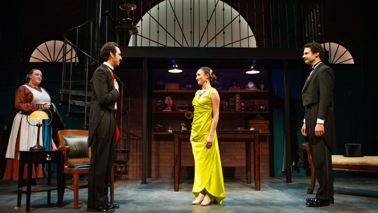 Mrs. Pearce (Heather Orth) watches as Colonel Pickering (Brady Morales-Woolery) acknowledges Eliza (Jillian A. Smith) as Professor Higgins (Adam Magill) looks on in San Francisco Playhouse's "My Fair Lady," performing July 3 - September 13, 2025. Mrs. Pearce (Heather Orth) watches as Colonel Pickering (Brady Morales-Woolery) acknowledges Eliza (Jillian A. Smith) as Professor Higgins (Adam Magill) looks on in San Francisco Playhouse's "My Fair Lady," performing July 3 - September 13, 2025.