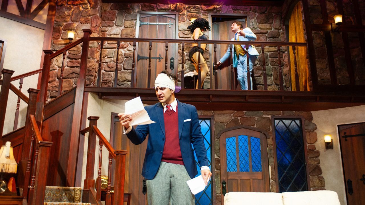 Frederick (Nima Rakhshanifar) reads the notice as Brooke (Sophia Alawi) is urged to hide by Garry (Joe Ayers) in San Francisco Playhouse's "Noises Off," performing September 25 - November 8. Frederick (Nima Rakhshanifar) reads the notice as Brooke (Sophia Alawi) is urged to hide by Garry (Joe Ayers) in San Francisco Playhouse's "Noises Off," performing September 25 - November 8.