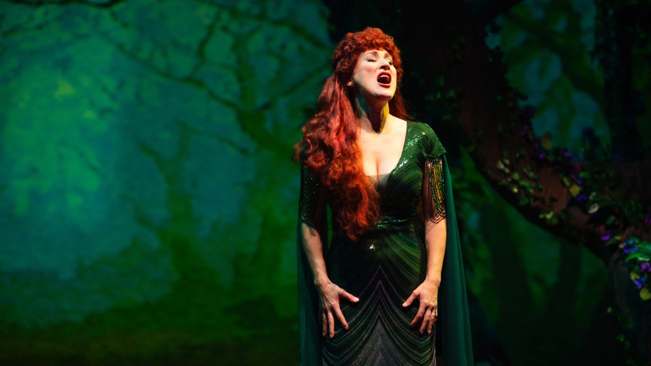 The Witch (Alison Ewing) considers the repercussions of her transformation in San Francisco Playhouse's "Into the Woods," performing November 20, 2025 - January 17, 2026. The Witch (Alison Ewing) considers the repercussions of her transformation in San Francisco Playhouse's "Into the Woods," performing November 20, 2025 - January 17, 2026.