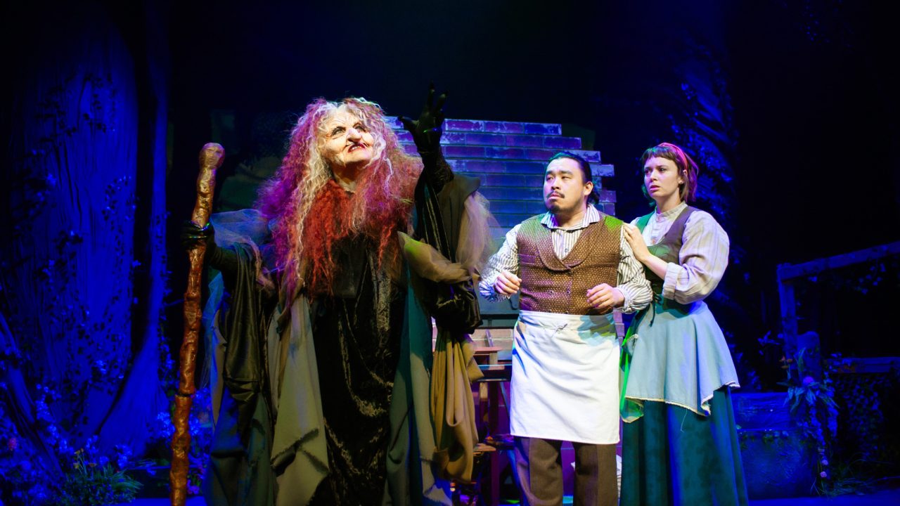 The Witch (Alison Ewing) makes a bargain with The Baker (Phil Wong) and his wife (Ruby Day) in San Francisco Playhouse's "Into the Woods," performing November 20, 2025 - January 17, 2026. The Witch (Alison Ewing) makes a bargain with The Baker (Phil Wong) and his wife (Ruby Day) in San Francisco Playhouse's "Into the Woods," performing November 20, 2025 - January 17, 2026.