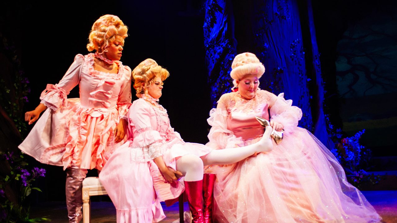 Florinda (Rachel Fobbs) watches as Lucinda (Callahan Gillespie) tries on the slipper with help from Cinderella's Stepmother (Heather Orth) in San Francisco Playhouse's "Into the Woods," performing November 20, 2025 - January 17, 2026. Florinda (Rachel Fobbs) watches as Lucinda (Callahan Gillespie) tries on the slipper with help from Cinderella's Stepmother (Heather Orth) in San Francisco Playhouse's "Into the Woods," performing November 20, 2025 - January 17, 2026.