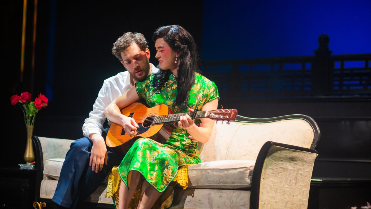 Rene Gallimard (Dean Linnard) listens to Song Liling (Edric Young) in San Francisco Playhouse's "M. Butterfly," performing February 5 - March 14, 2026. Rene Gallimard (Dean Linnard) listens to Song Liling (Edric Young) in San Francisco Playhouse's "M. Butterfly," performing February 5 - March 14, 2026.