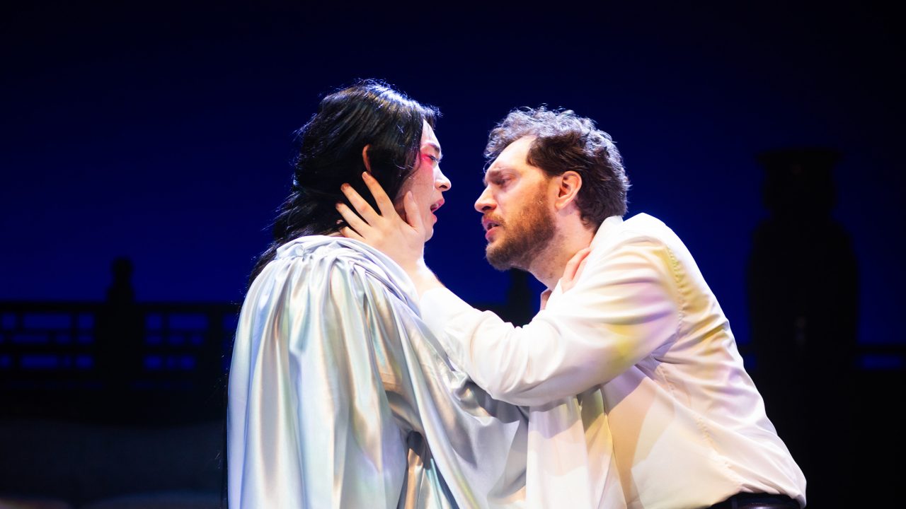 Song Liling (Edric Young) and Rene Gallimard (Dean Linnard) embrace in San Francisco Playhouse's "M. Butterfly," performing February 5 - March 14, 2026. Song Liling (Edric Young) and Rene Gallimard (Dean Linnard) embrace in San Francisco Playhouse's "M. Butterfly," performing February 5 - March 14, 2026.