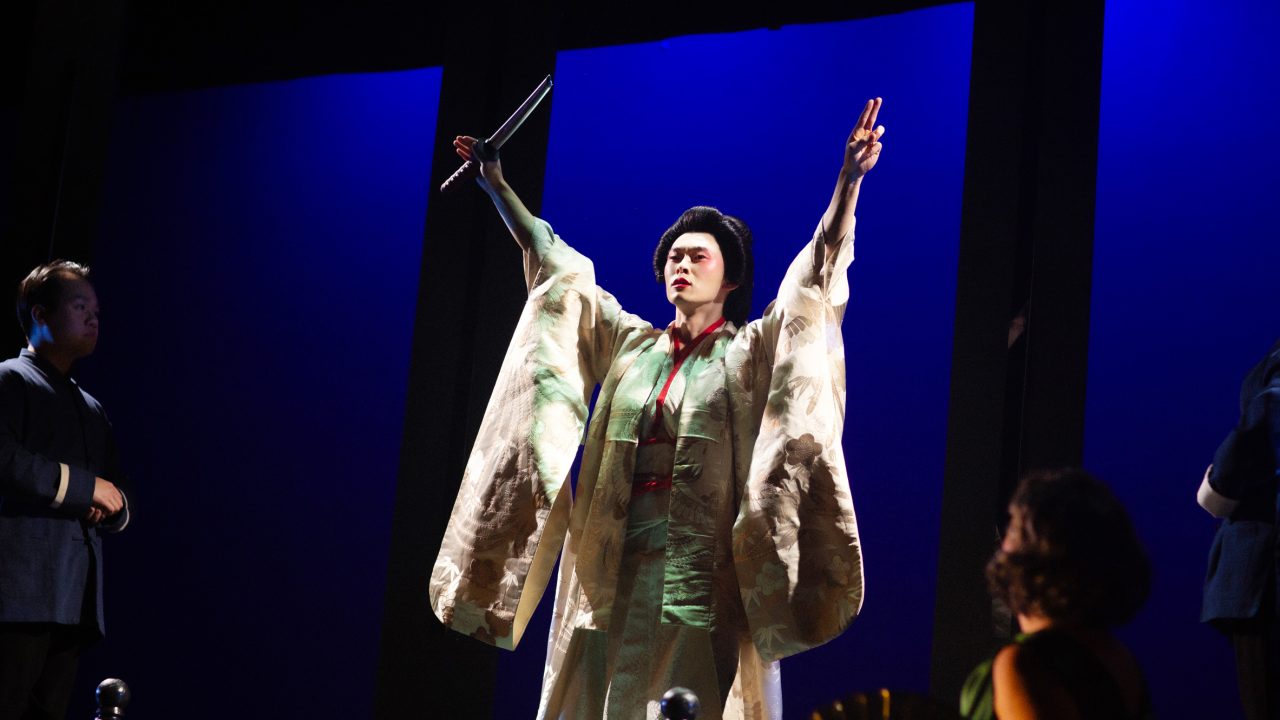 An attendant (Anthony Doan) watches Song Liling (Edric Young) in San Francisco Playhouse's "M. Butterfly," performing February 5 - March 14, 2026. An attendant (Anthony Doan) watches Song Liling (Edric Young) in San Francisco Playhouse's "M. Butterfly," performing February 5 - March 14, 2026.