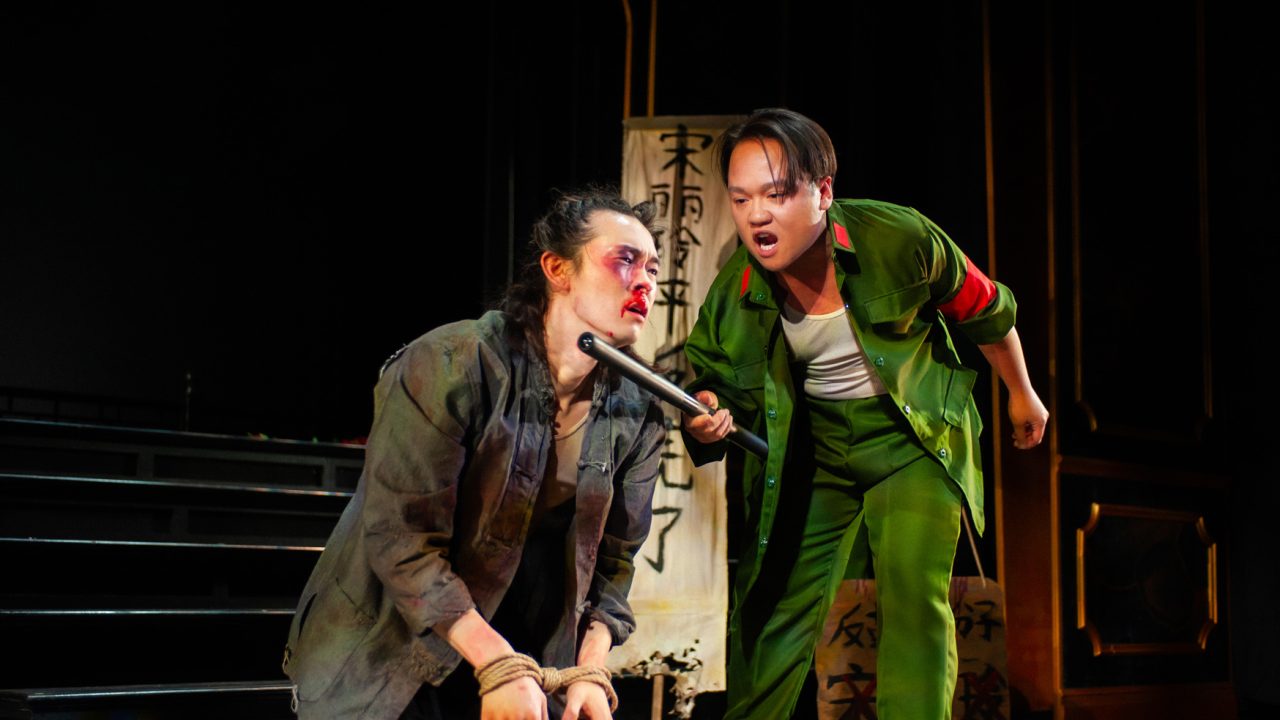 Song Liling (Edric Young) is punished by Comrade Chin (Anthony Doan) in San Francisco Playhouse's "M. Butterfly," performing February 5 - March 14, 2026. Song Liling (Edric Young) is punished by Comrade Chin (Anthony Doan) in San Francisco Playhouse's "M. Butterfly," performing February 5 - March 14, 2026.