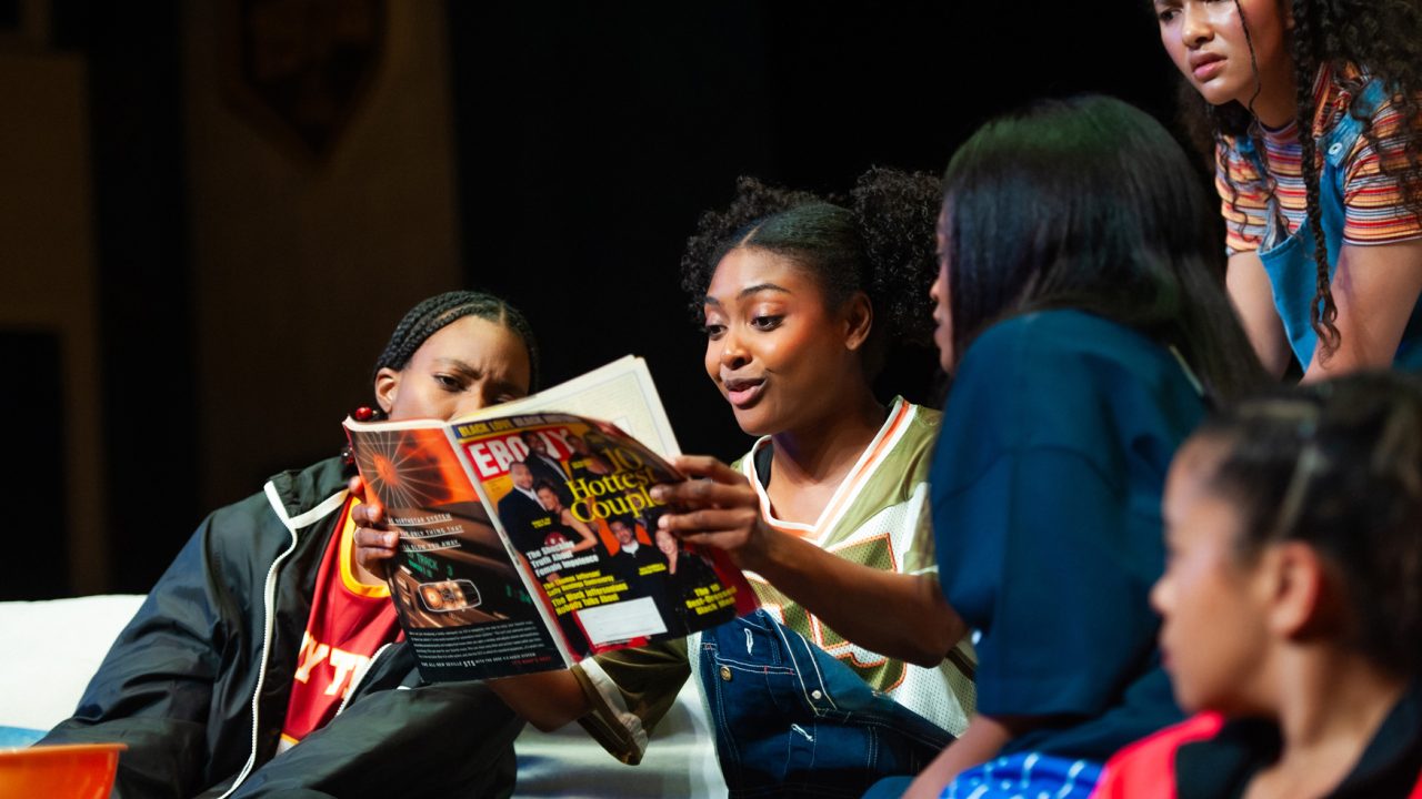 Lady Train teammates (l to r: Santeon Brown, Courtney Gabrielle Williams, Paige Mayes, Emma Gardner, and Camille Collaço) read a magazine in San Francisco Playhouse's "Flex," performing March 26 - May 2, 2026. Lady Train teammates (l to r: Santeon Brown, Courtney Gabrielle Williams, Paige Mayes, Emma Gardner, and Camille Collaço) read a magazine in San Francisco Playhouse's "Flex," performing March 26 - May 2, 2026.