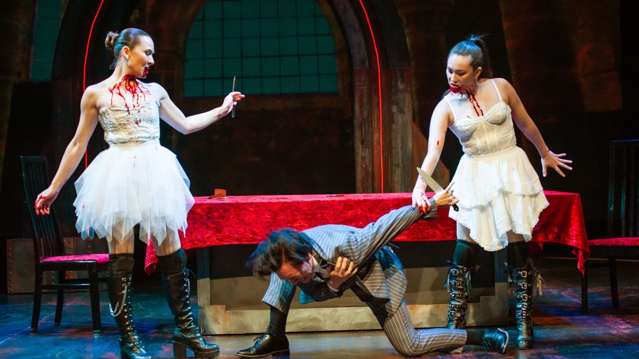 Marilla (Charisse Loriaux) taunts Jonathan (James Aaron Oh) who is ensnared by Drusilla (Elizabeth Cowperthwaite) in San Francisco Playhouse's "Dracula: A Feminist Revenge Fantasy, Really," performing May 14 - June 27.