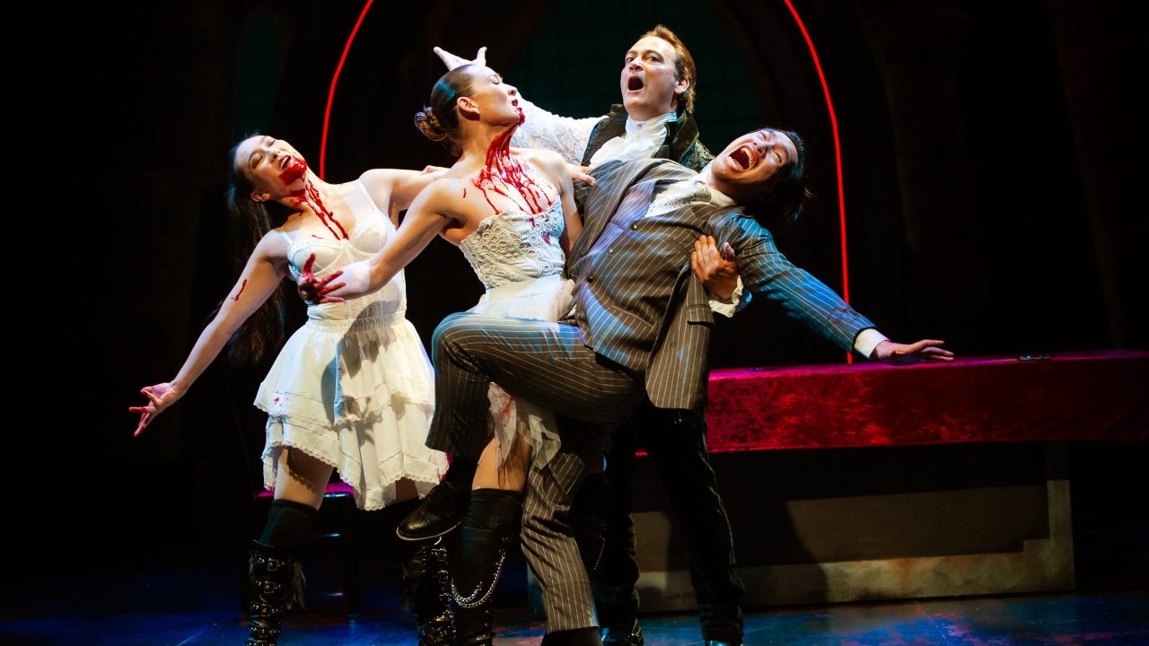 Drusilla (Elizabeth Cowperthwaite), Marilla (Charisse Loriaux), and Dracula (Johnny Moreno) are eager to feed on Jonathan (James Aaron Oh) in San Francisco Playhouse's "Dracula: A Feminist Revenge Fantasy, Really," performing May 14 - June 27.
