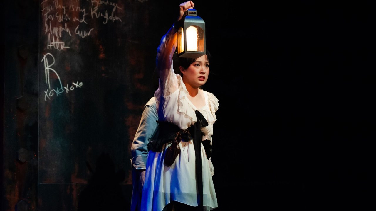 Mina (Sharon Shao) approaches danger lurking in the shadows in San Francisco Playhouse's "Dracula: A Feminist Revenge Fantasy, Really," performing May 14 - June 27.