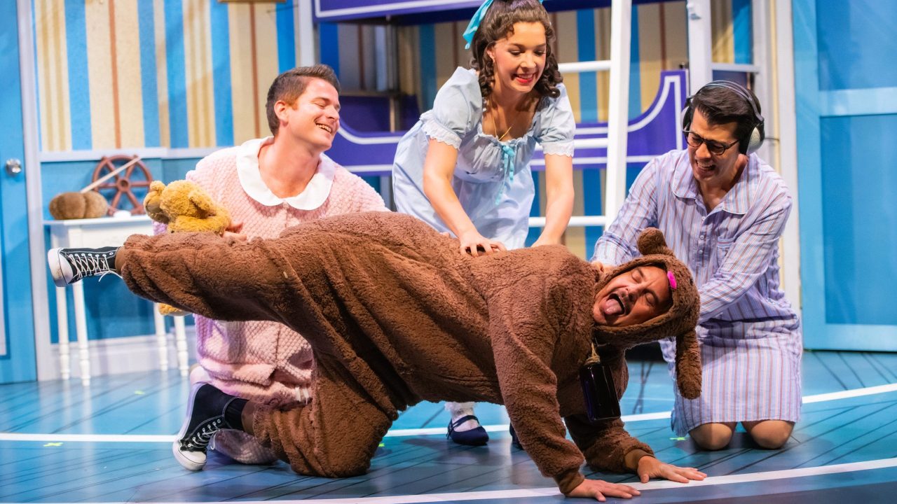 The Darling children (l to r: Joe Ayers, Maggie Mason, and Greg Ayers) pet Nana (Patrick Russell) in San Francisco Playhouse's "Peter Pan Goes Wrong," performing September 26 - November 28.