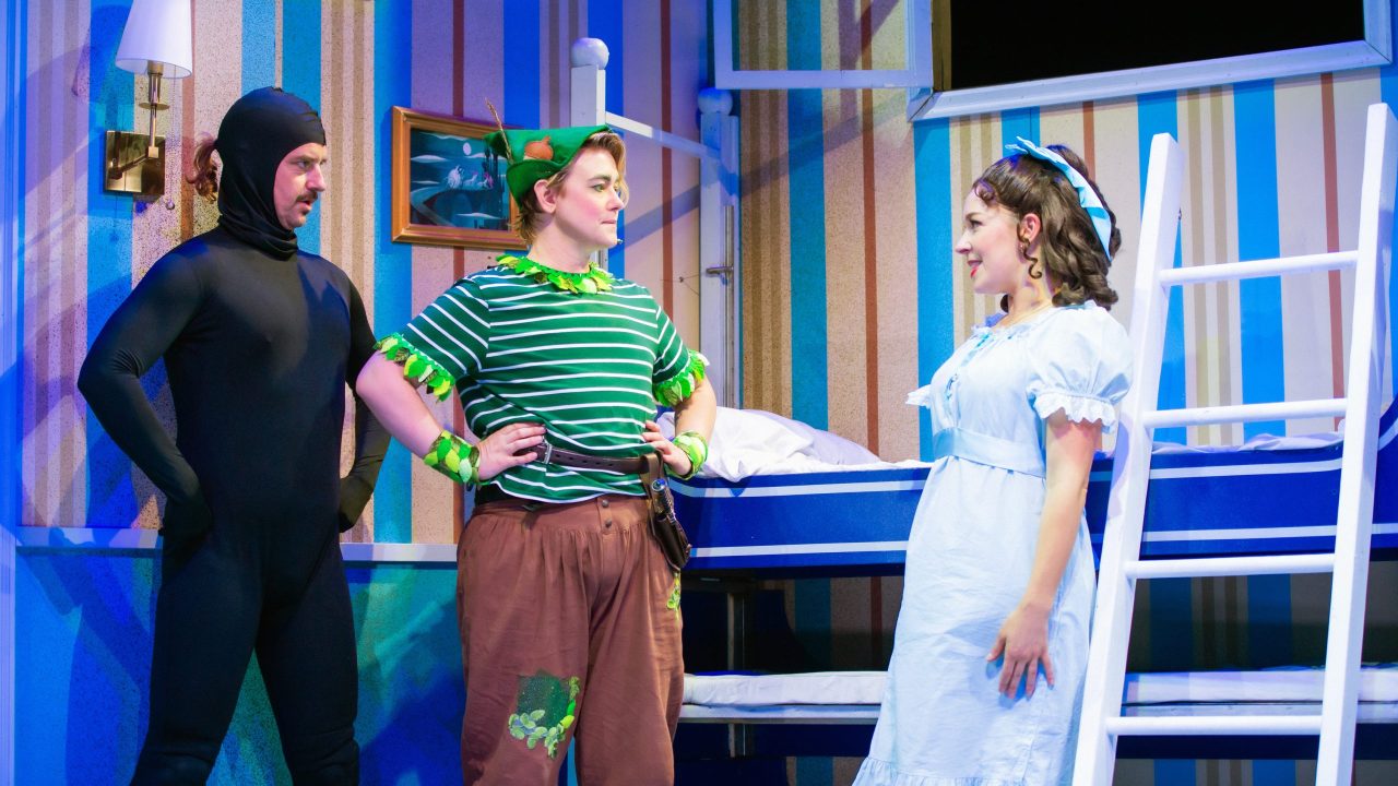 Peter's shadow (Patrick Russell) mirrors Peter (Ezra Reaves) during a discussion with Wendy (Maggie Mason) in San Francisco Playhouse's "Peter Pan Goes Wrong," performing September 26 - November 28.